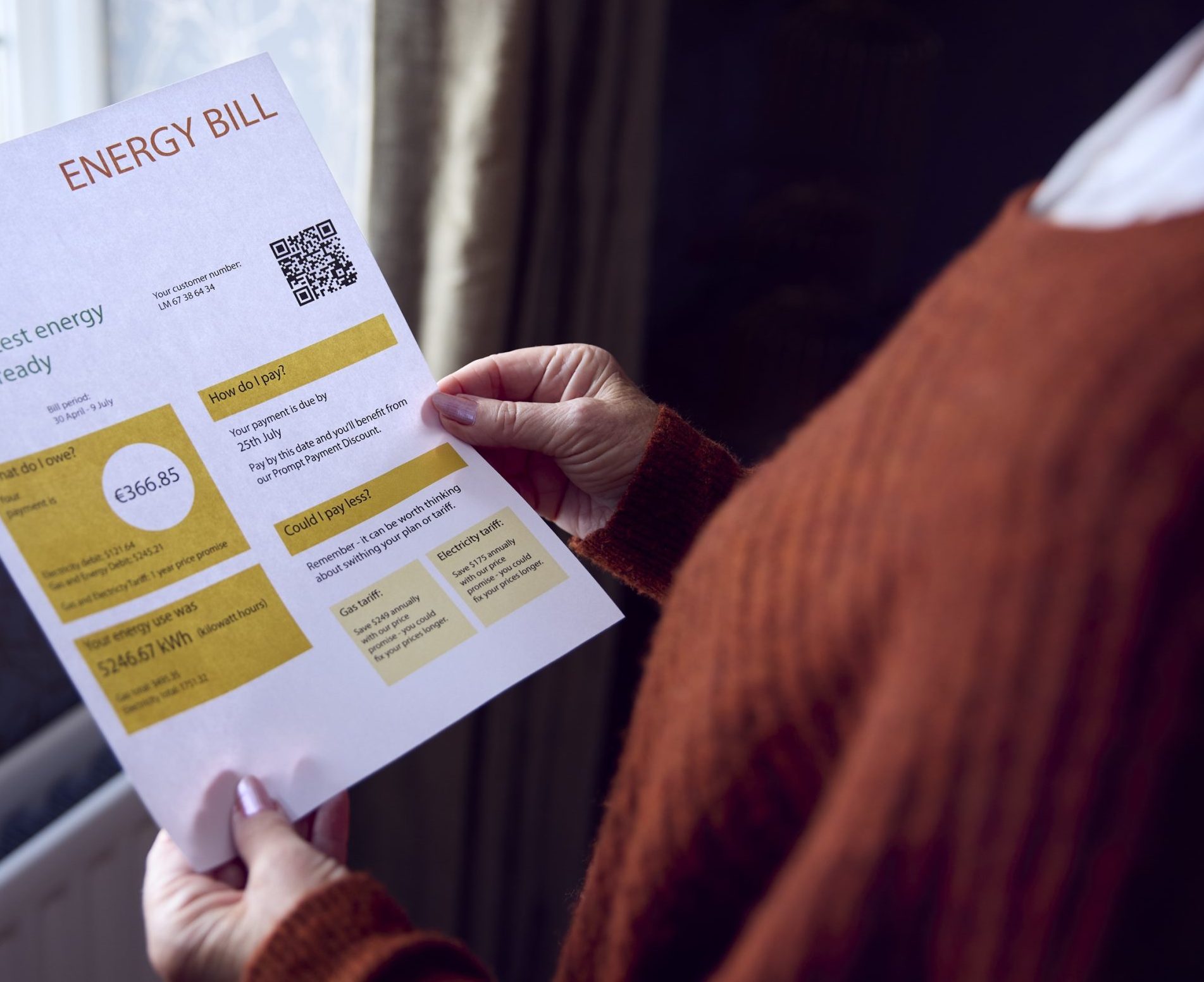 Senior Woman With Mobile phone energy bill